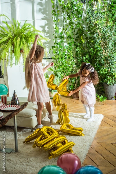Obraz girls, Sisters joyfully embracing each other in a lush and cozy living space filled with warmth