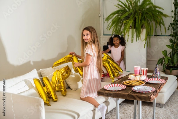 Obraz girls, Sisters joyfully embracing each other in a lush and cozy living space filled with warmth