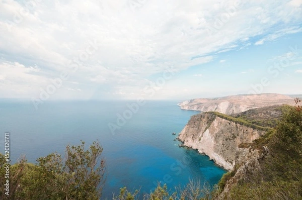 Obraz Stunning cliffs rise dramatically from vibrant blue waters, inviting summer adventurers to explore Zakynthos' natural beauty