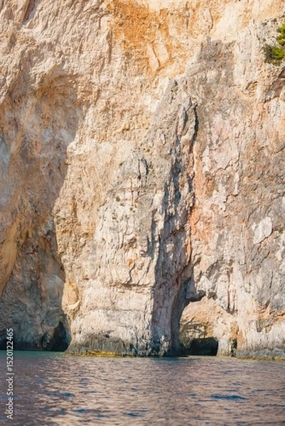 Obraz Tourists bask in the warm Mediterranean sun as they discover the stunning rocky cliffs of Zakynthos, surrounded by crystal-clear turquoise waters on a summer afternoon