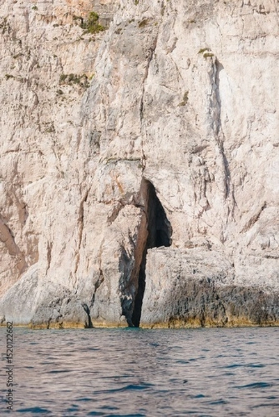 Obraz Kayaking along the crystal-clear waters reveals breathtaking coastal caves of Zakynthos, where sunlight dances on the limestone cliffs, creating a magical atmosphere