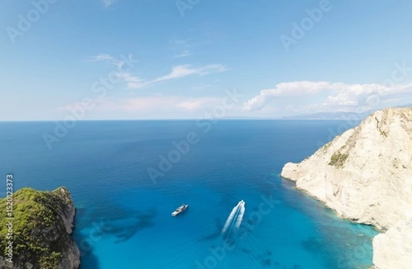 Obraz Exploring the stunning coast of Zakynthos in summer showcases deep blue waters and picturesque cliffs, with boats enjoying the sunny weather and tranquil surroundings