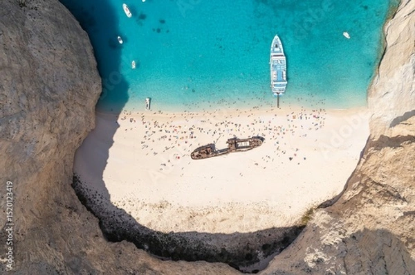 Obraz Discover the breathtaking beauty of Zakynthos as sun-seekers enjoy the sandy beach below towering cliffs. Clear blue waters invite relaxation and adventure, perfect for a summer escape