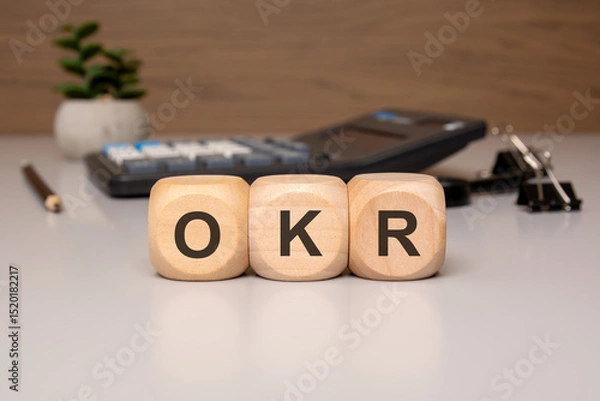 Obraz Wooden blocks with the letters OKR on office desk background