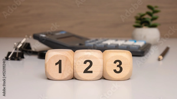 Obraz Wooden blocks with numbers 1, 2, and 3 on office desk