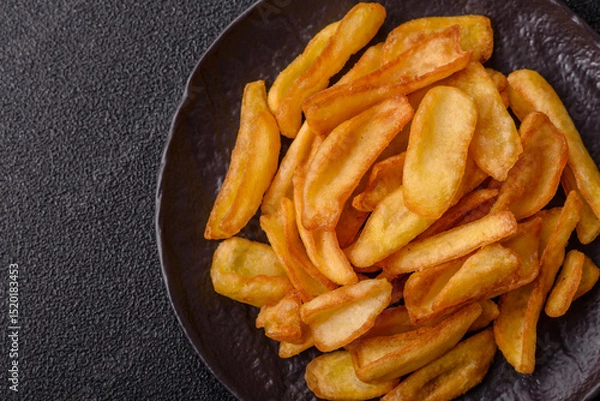Obraz Fried crispy French fries with salt, spices, food for lunch