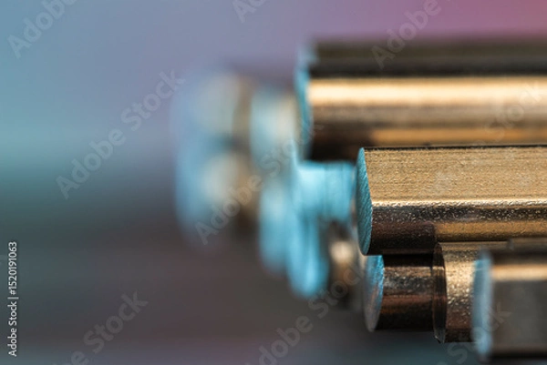 Obraz A stack of cut steel bars and non-ferrous metal rods, close-up view with a blurred background