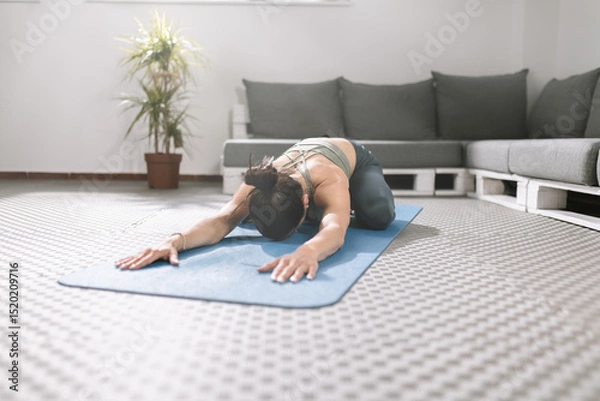 Obraz Practicing yoga during morning indoors focusing on relaxation and flexibility in a peaceful setting