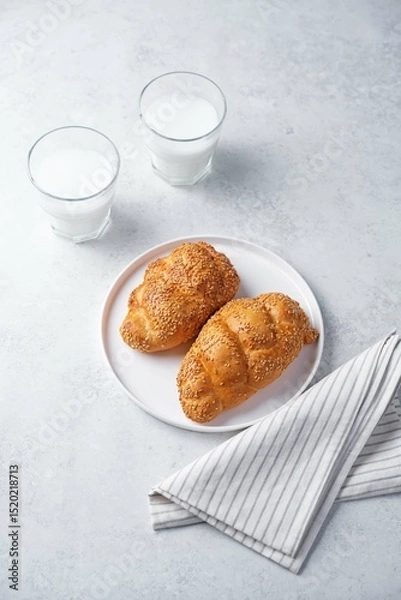 Obraz Sesame seeds braided bun on a white background