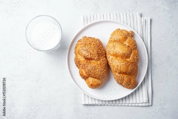 Obraz Sesame seeds braided bun on a white background