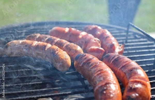 Obraz Sausages being cooked on the grill