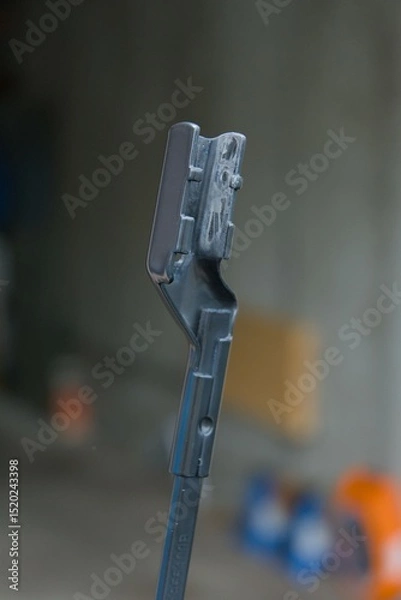 Fototapeta A close-up reveals a sleek, dark grey mechanical component, highlighting its intricate design and robust construction. Perfect for technical applications.