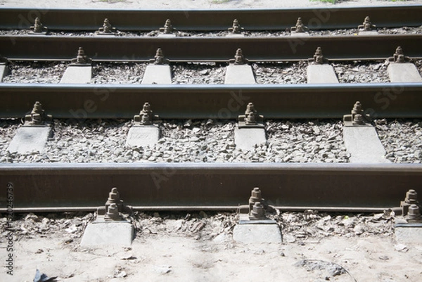 Fototapeta close-up of tram rails and concrete sleepers covered with crushed stone