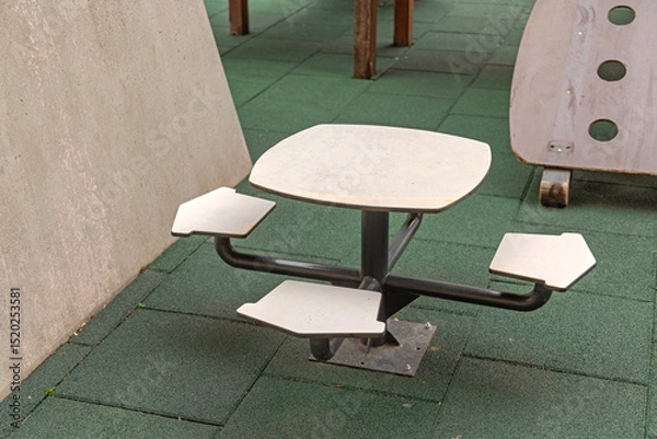 Fototapeta Floor Mounted Table With Chairs Set at Playground in City Park