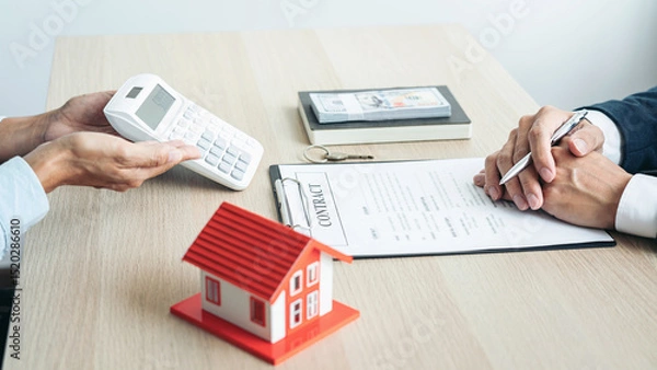 Obraz Real estate broker agent consulting the customer to a decision making sign insurance form agreement contract