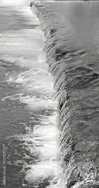 Fototapeta Vertical, black and white image. River mountain rapids. Dynamic composition. Abstract forms