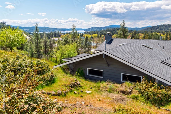 Fototapeta View of Lake Coeur d'Alene from a hilltop mid century home in Coeur d'Alene, Idaho, USA at autumn.