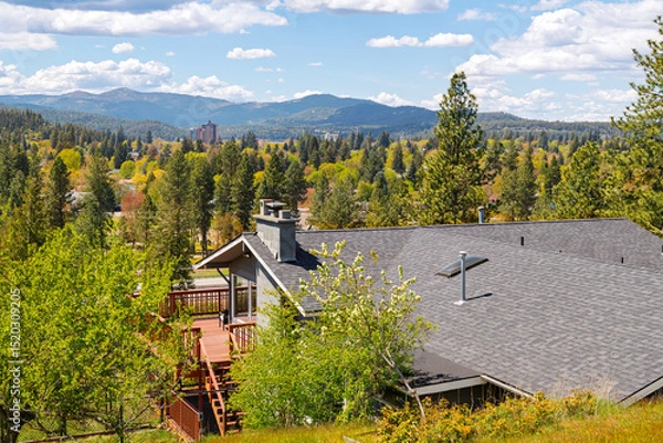 Fototapeta View from a mid century hillside home of McEuen Tower in the downtown district and the hills of the city of Coeur d'Alene, Idaho, from the Fernan Lake area.