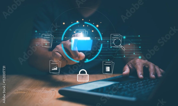Fototapeta Document management system, Managing corporate files. Businessman using laptop computer for manage information, Online documentation database and process to efficiently manage files. Files protection.
