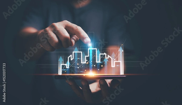 Fototapeta Real estate investment concept, Businessman holding smartphone with arrow up and graph corporate plan. Analyzing data with financial growth and business. High demand and rising price for real estate.