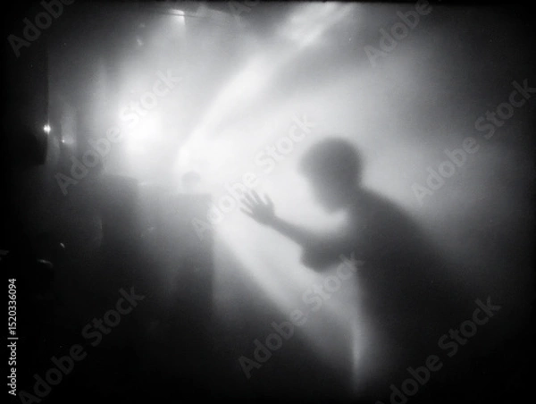 Fototapeta blurry photograph of a hand reaching out from a dark, unseen space