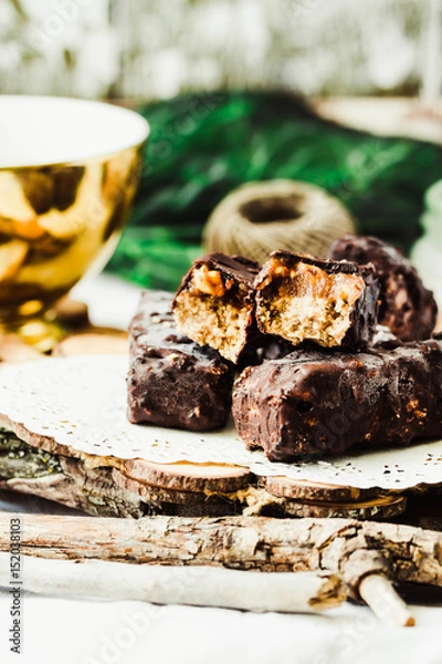 Obraz Homemade raw chocolate candy snickers bars. Selective focus.