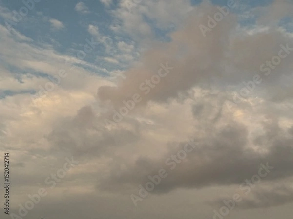 Obraz calm sky photo with soft and thin clouds golden light of the sun, light and shadow on the clouds create texture, bright blue sky calming background. Suitable for nature, tranquility, weather, freedom