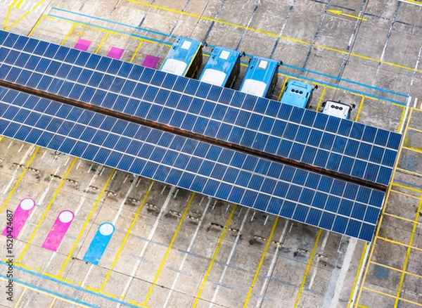 Obraz Aerial view above innovative solar panels located on a bus parking lot rooftops