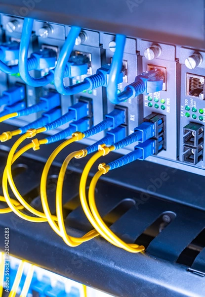Obraz server with fiber optic cables  and network cable in data center