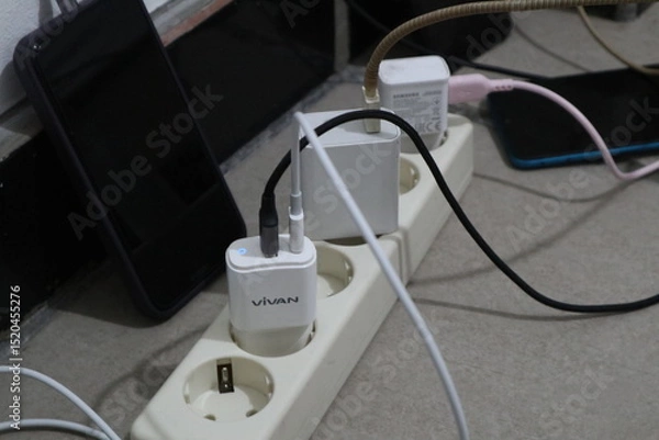 Fototapeta Jepara, 22 Juni 2025  - smartphone charger plugged into an electrical terminal