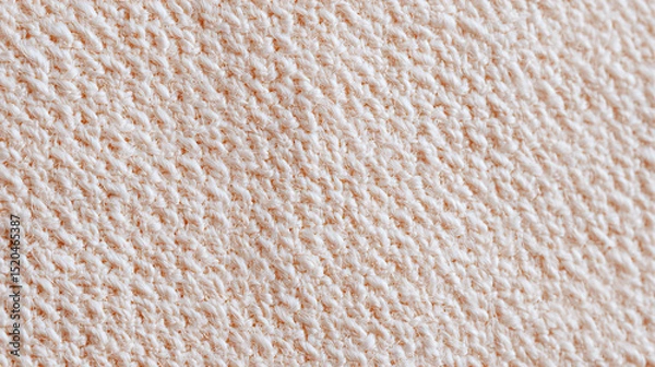 Fototapeta Close up detailed texture of soft beige knitted fabric showing warm cozy pattern and natural fiber threads for textile and fashion background