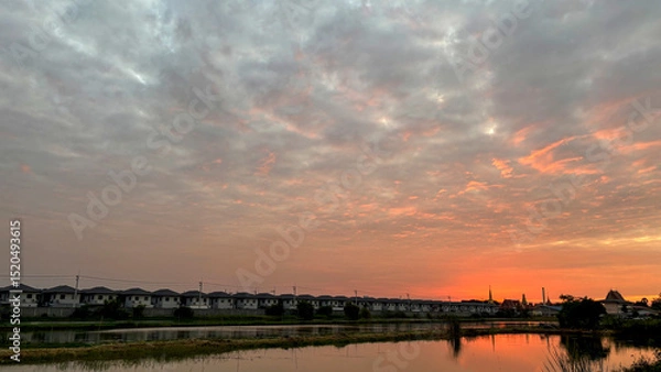 Fototapeta Scenic View of a Quiet Village at Dusk, Gently Bathed in the Warm Golden Light of the Setting Sun