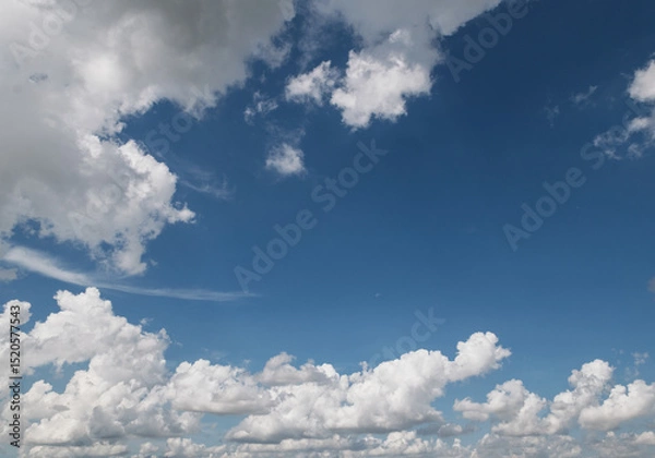 Fototapeta The sky is blue with a few clouds scattered throughout