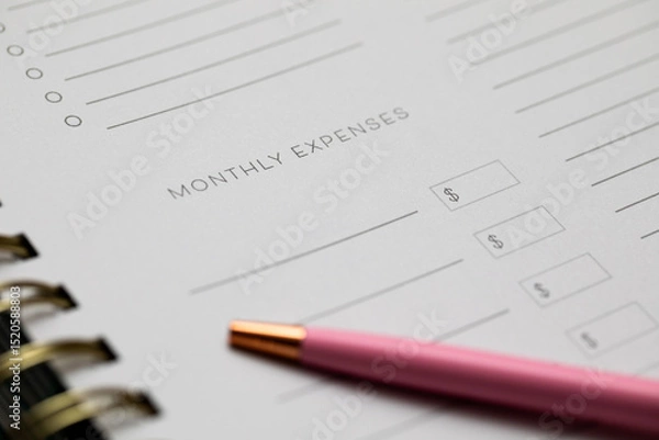 Fototapeta monthly expenses on a notebook with a bright pink pen