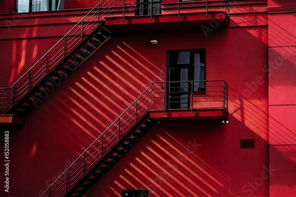 Fototapeta red building with stairs and shadows
