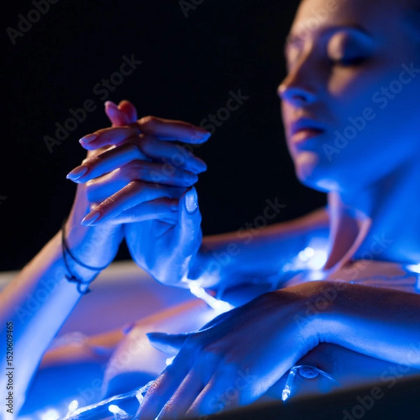 Fototapeta Intimate moment with blue lights illuminating a serene atmosphere
