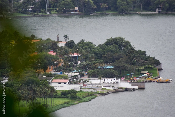 Fototapeta Photograph of a construction created on the shore of a lake surrounded by water