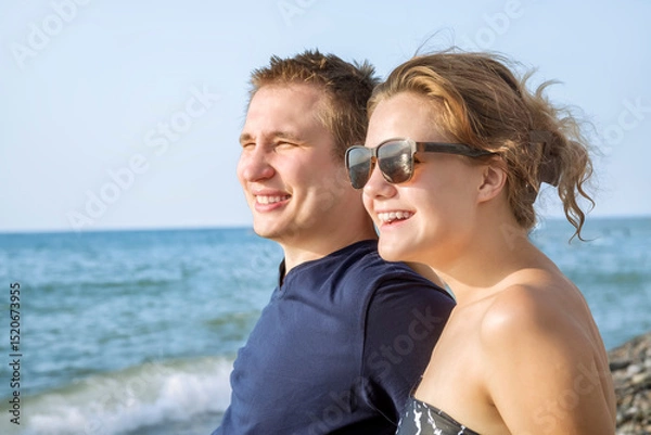 Fototapeta Portrait of a young couple on the background of the sea. Rest on the shore of the warm sea. Close-up