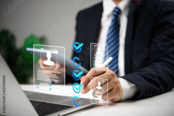 Fototapeta Businessman using digital interface to select candidates with virtual profile icons and checkmarks, representing modern recruitment, HR human resources technology, and hiring process.