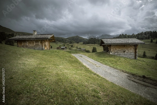 Obraz small house over a mountain pasture in Dolomites with wonderful panorama