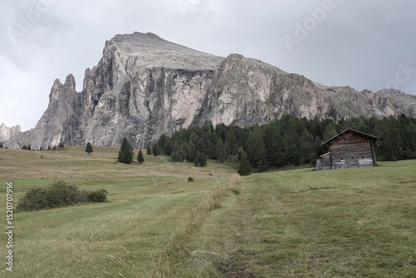 Obraz small house over a mountain pasture in Dolomites with wonderful panorama