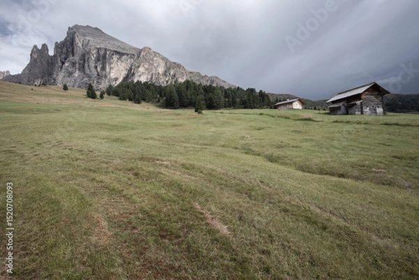 Obraz small house over a mountain pasture in Dolomites with wonderful panorama