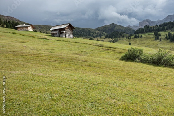 Obraz small house over a mountain pasture in Dolomites with wonderful panorama