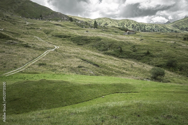 Obraz small house over a mountain pasture in Dolomites with wonderful panorama