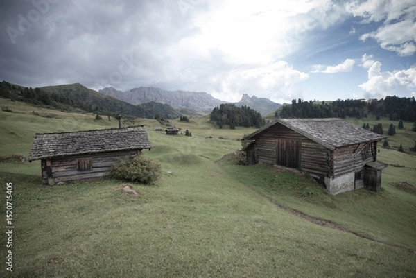Obraz small house over a mountain pasture in Dolomites with wonderful panorama