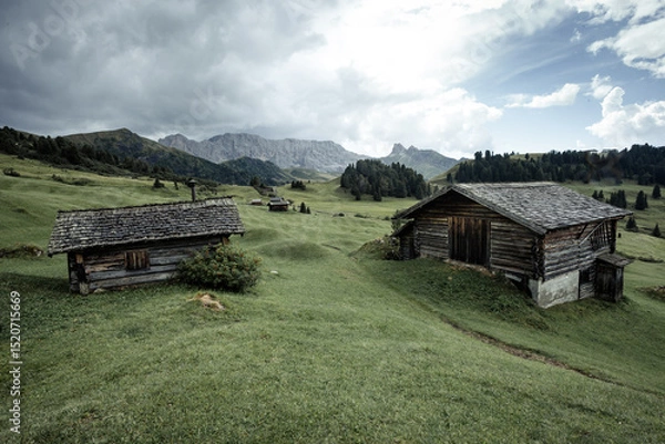 Obraz small house over a mountain pasture in Dolomites with wonderful panorama