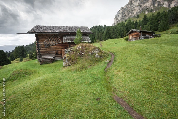Obraz small house over a mountain pasture in Dolomites with wonderful panorama