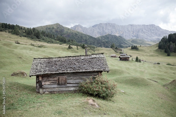 Obraz small house over a mountain pasture in Dolomites with wonderful panorama
