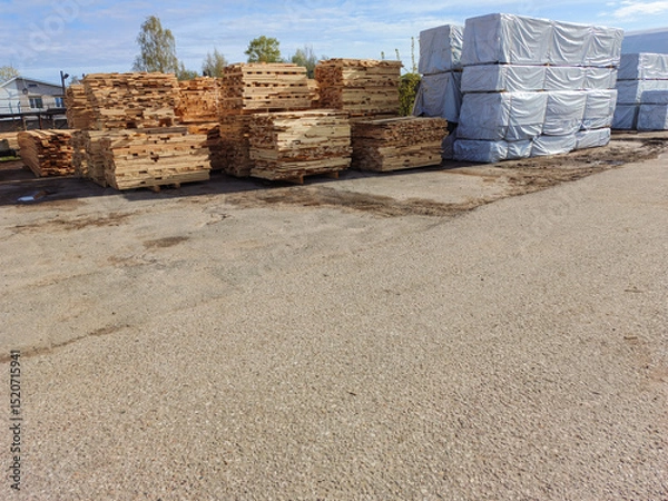 Fototapeta Lumber, boards, stacked. Products packed in polyethylene.