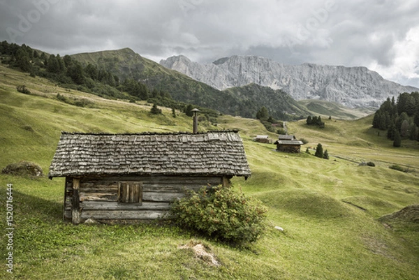 Obraz small house over a mountain pasture in Dolomites with wonderful panorama